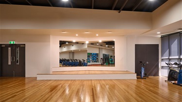 It features mirrored walls, sound system, and a stage