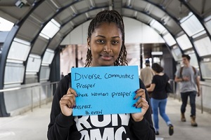 Woman holding sign up at Footscray Train Station
