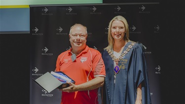 Mayor Cr Sarah Carter presenting the 2023 Active Maribyrnong Sporting Award to Shaun Hudson, President on behalf of the West Footscray Football Club.
