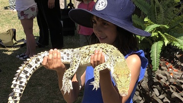 Kids were able to handle a real life blonde crocodile.
