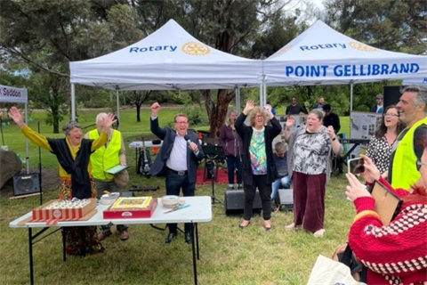 Celebration at Cruickshank Park with Councillor Clarke and residents Lola and Peter Anderson cutting the cake.