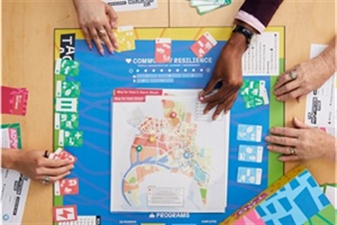 Photo of hands playing a board game